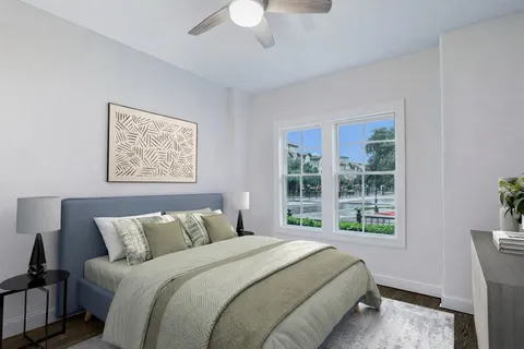 a bedroom with a bed and wooden floor