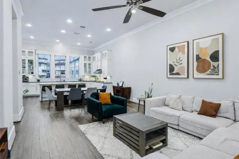 a living room with furniture and wooden floor