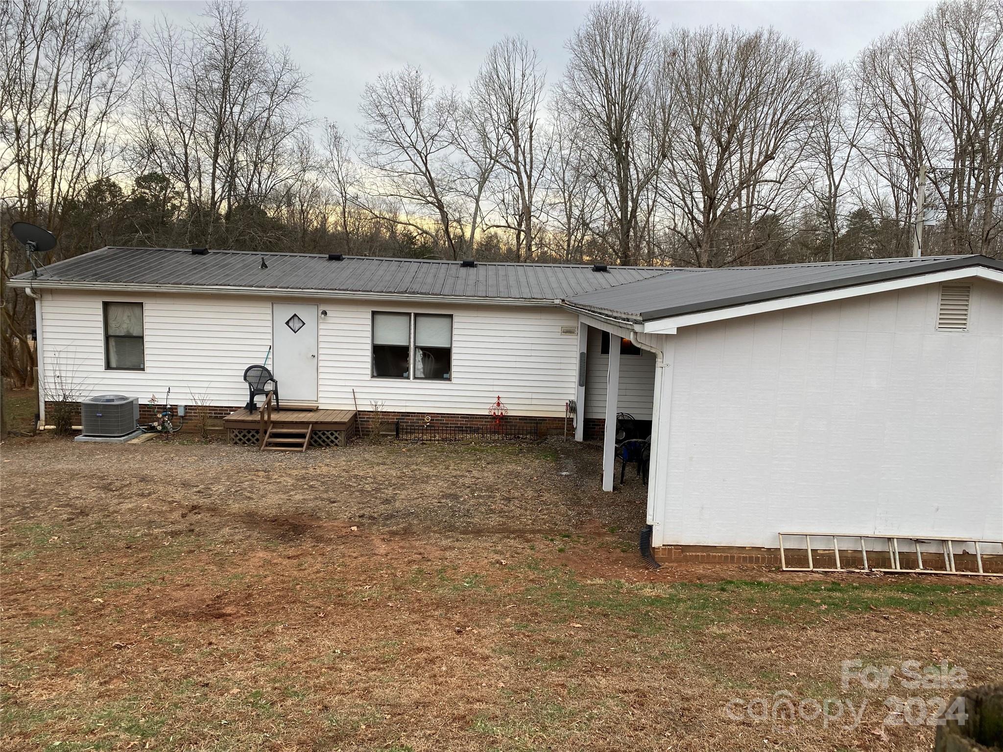 1715 Hopewell Church Road Hiddenite, NC 28636 - Photo 15 of 46 a view of a house with backyard and trees