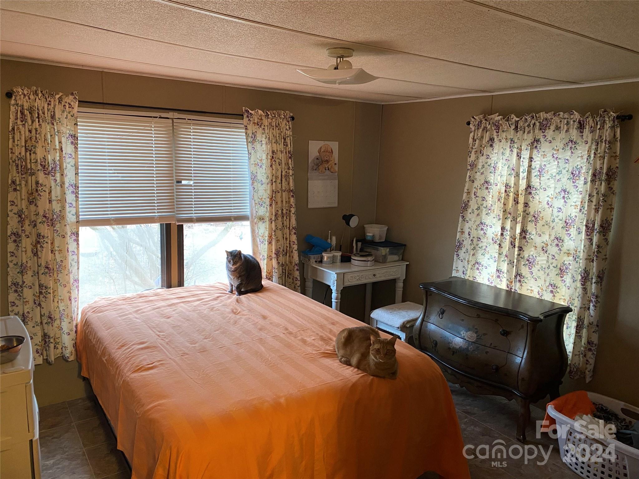 1715 Hopewell Church Road Hiddenite, NC 28636 - Photo 21 of 46 a large bed sitting in a bedroom next to a window
