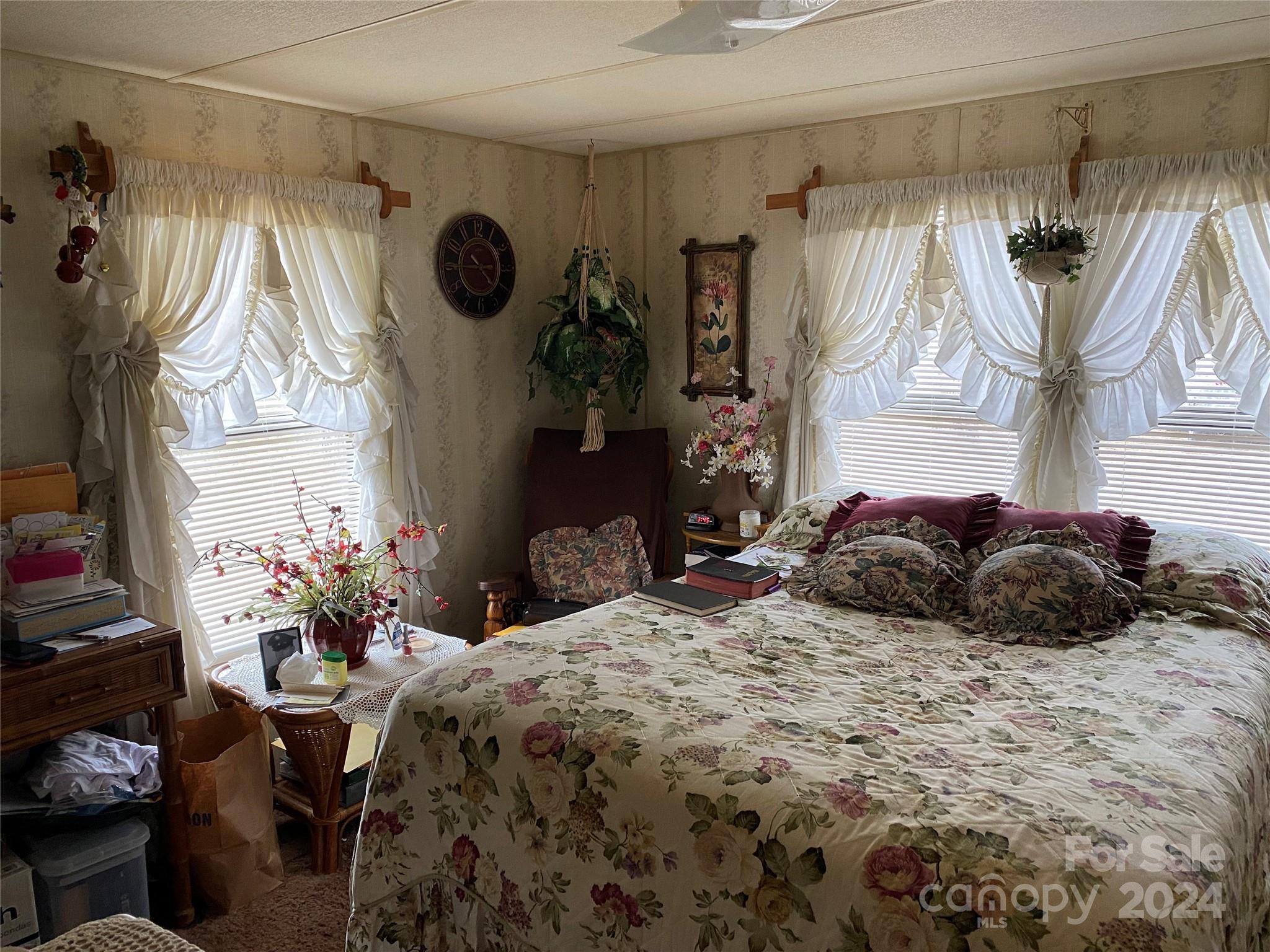 1715 Hopewell Church Road Hiddenite, NC 28636 - Photo 24 of 46 a large bed and a night stand sitting in a bedroom
