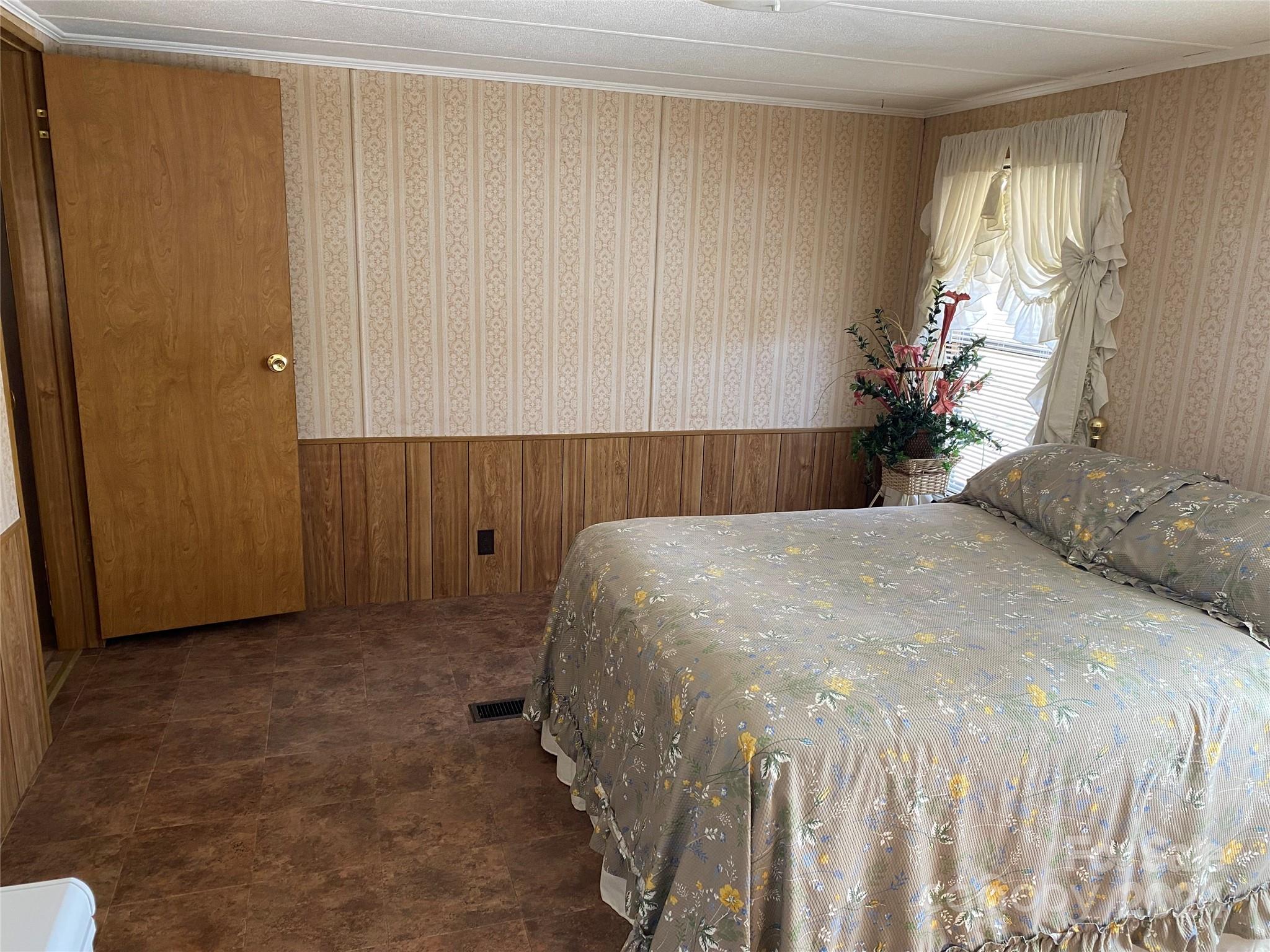 1715 Hopewell Church Road Hiddenite, NC 28636 - Photo 25 of 46 a bedroom with a bed and a window