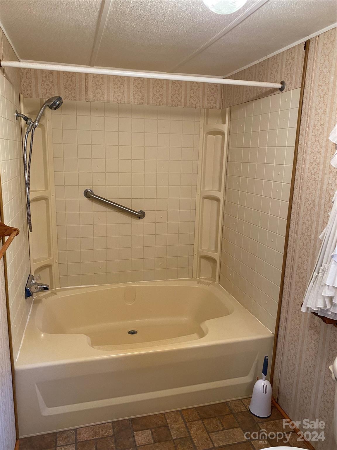 1715 Hopewell Church Road Hiddenite, NC 28636 - Photo 28 of 46 a bathroom with a shower and a bath tub