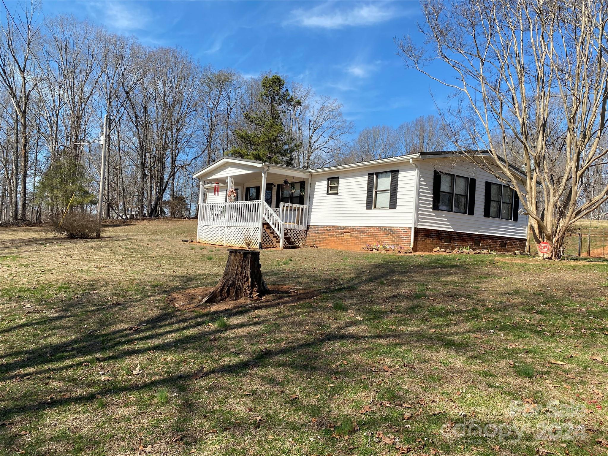 1715 Hopewell Church Road Hiddenite, NC 28636 - Photo 29 of 46 a front view of a house with a yard covered with snow