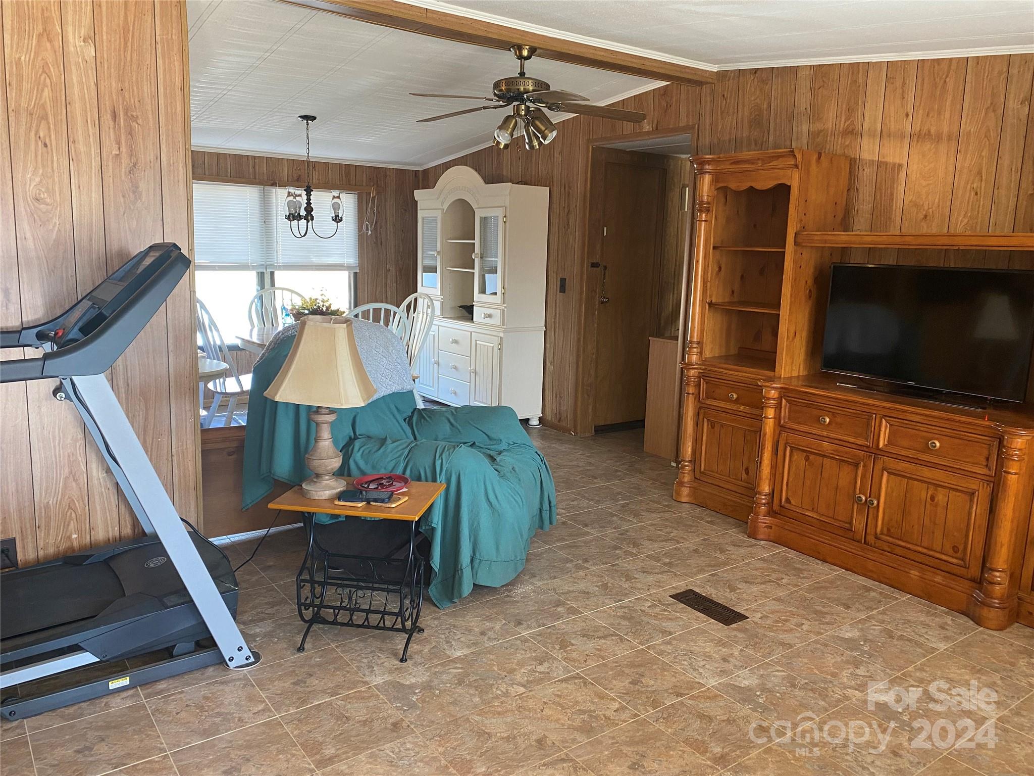 1715 Hopewell Church Road Hiddenite, NC 28636 - Photo 38 of 46 a living room with furniture a flat screen tv and floor to ceiling window