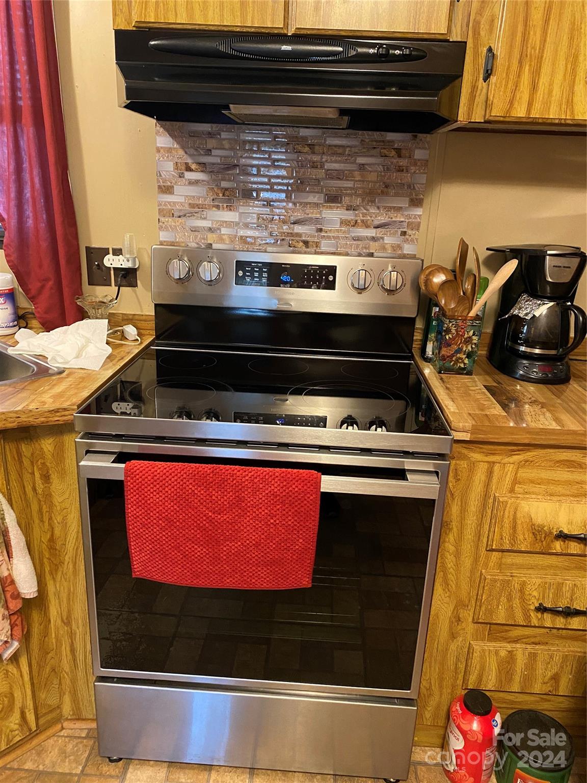 1715 Hopewell Church Road Hiddenite, NC 28636 - Photo 9 of 46 a stove top oven sitting inside of a kitchen