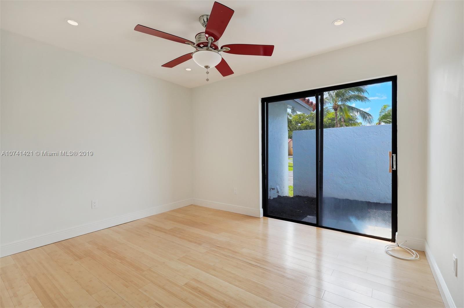 15041 Southwest 96th Terrace Miami, FL 33196 - Photo 11 of 16 wooden floor in an empty room with a window