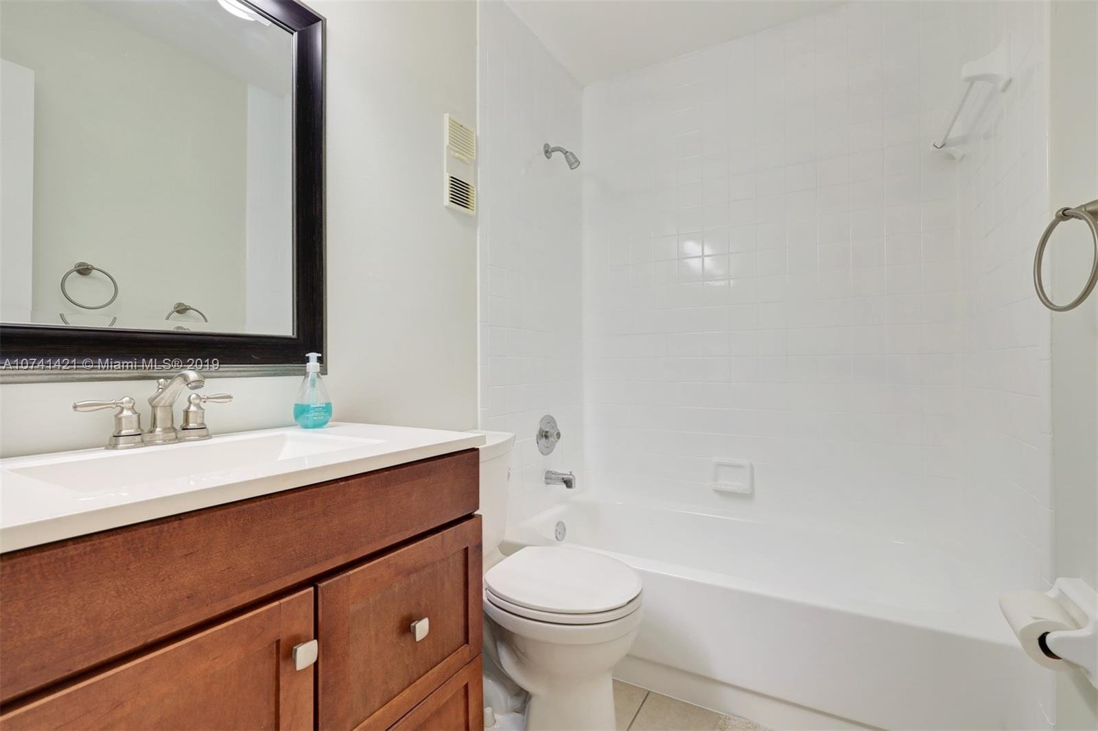 15041 Southwest 96th Terrace Miami, FL 33196 - Photo 12 of 16 a bathroom with a sink a toilet and shower