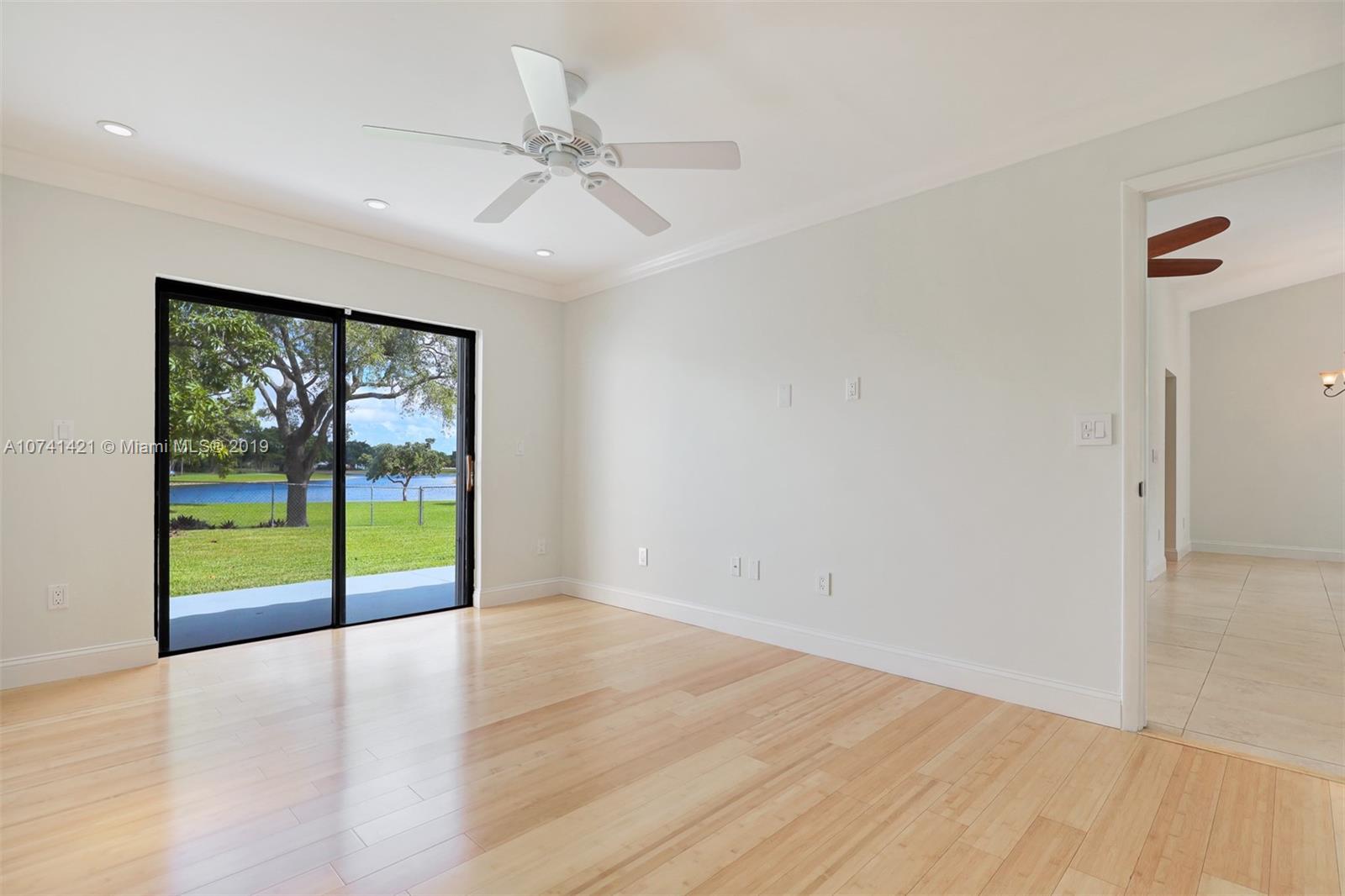 15041 Southwest 96th Terrace Miami, FL 33196 - Photo 13 of 16 wooden floor in an empty room with a window