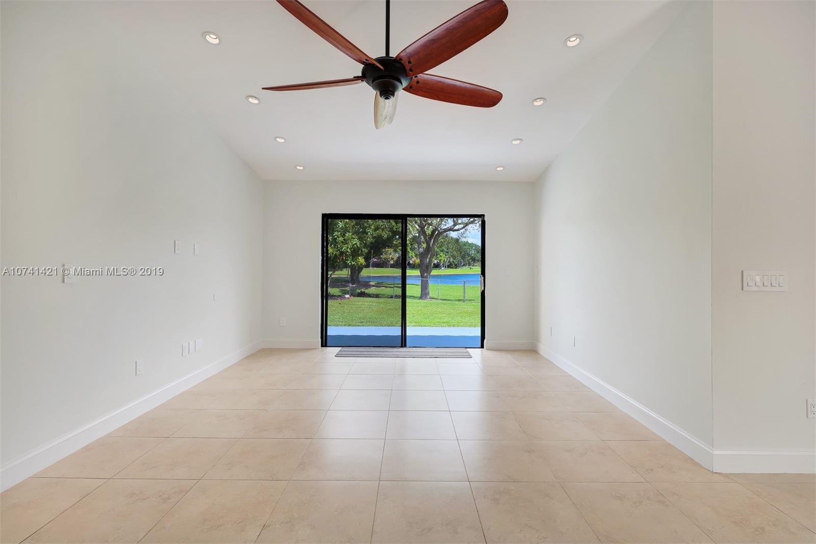 15041 Southwest 96th Terrace Miami, FL 33196 - Photo 9 of 16 a view of an empty room with a window