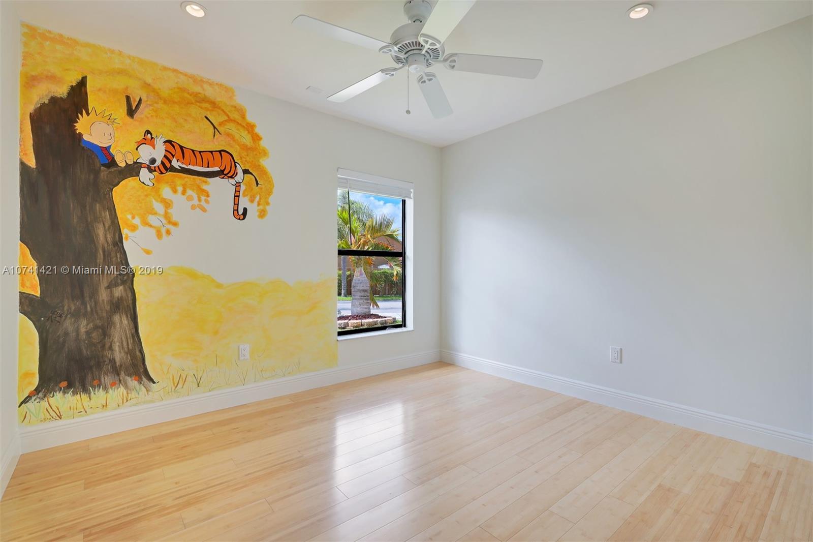 15041 Southwest 96th Terrace Miami, FL 33196 - Photo 10 of 16 an empty room with a window and wooden floor