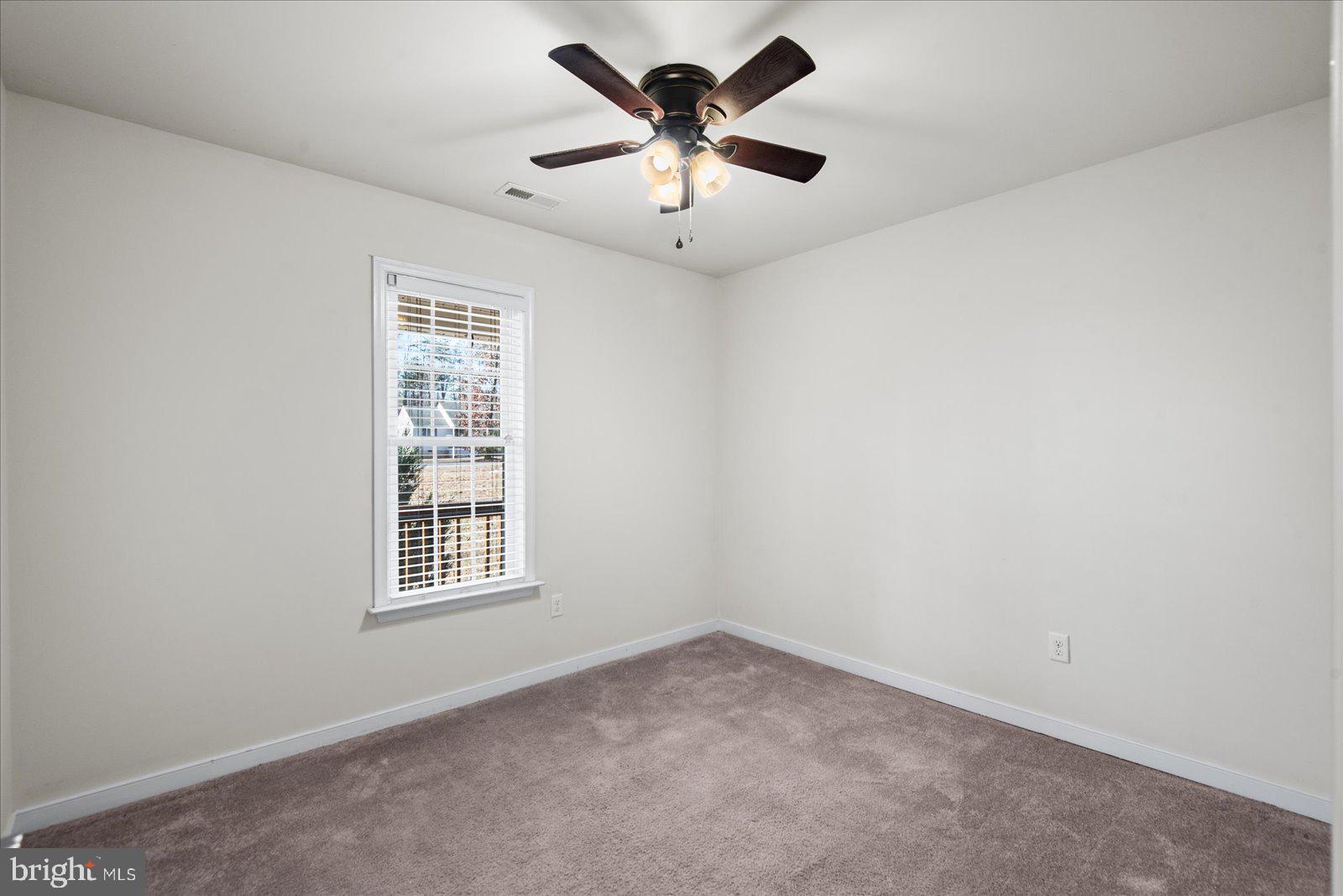 357 Winding Ridge Way Bumpass, VA 23024 - Photo 23 of 31 an empty room with windows and fan