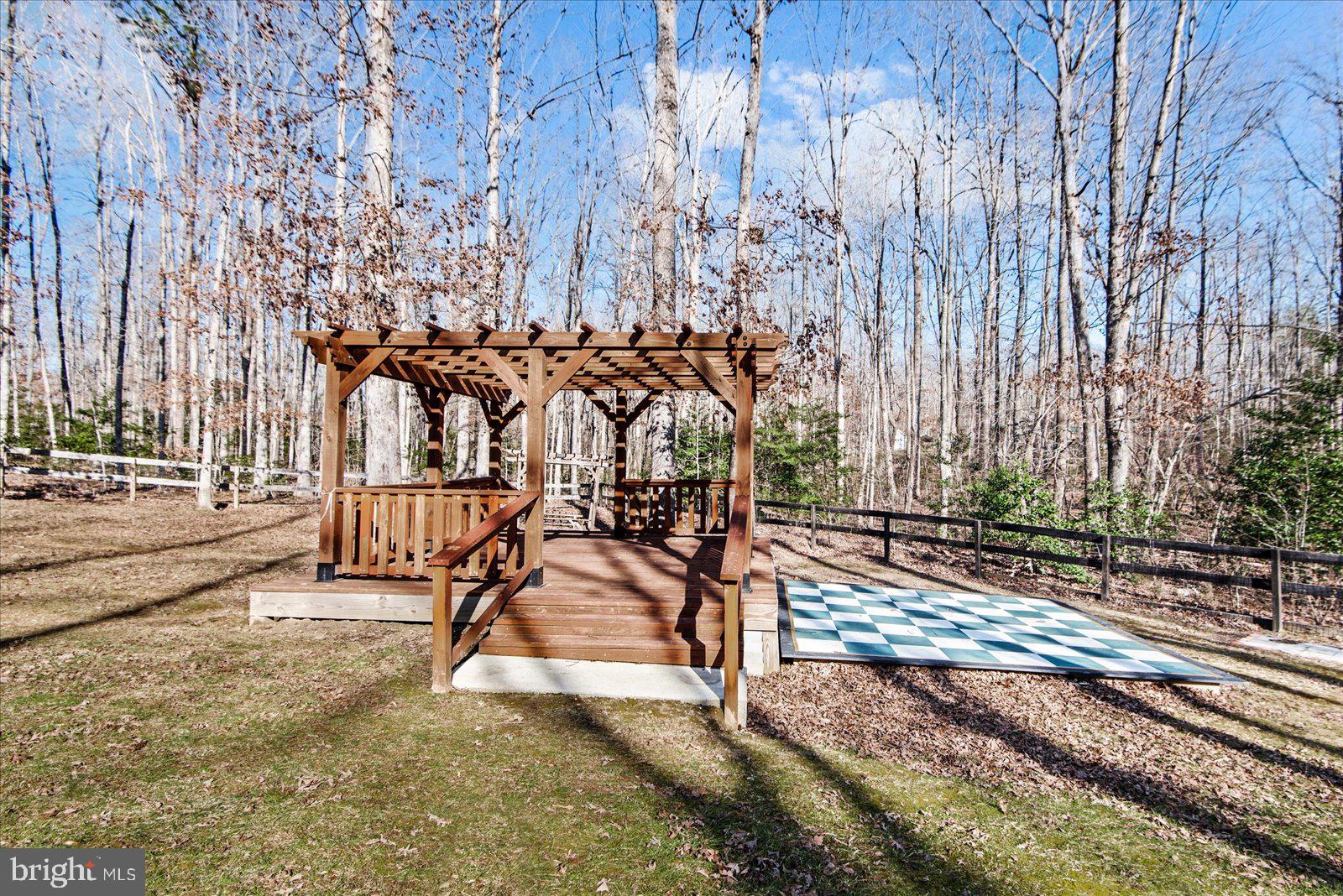 357 Winding Ridge Way Bumpass, VA 23024 - Photo 27 of 31 a view of a backyard with a bench