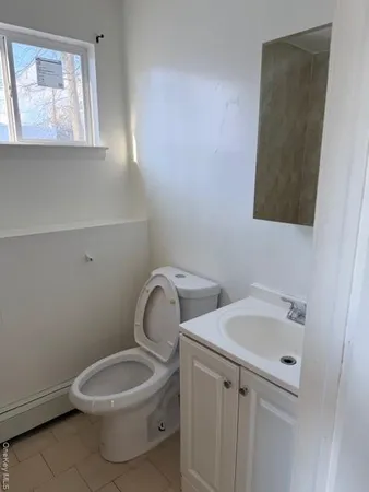 a white toilet sitting next to a bathroom sink