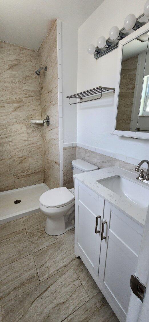 3831 Beacon Hill Road Jupiter, FL 33469 - Photo 5 of 9 a bathroom with a sink a toilet and shower