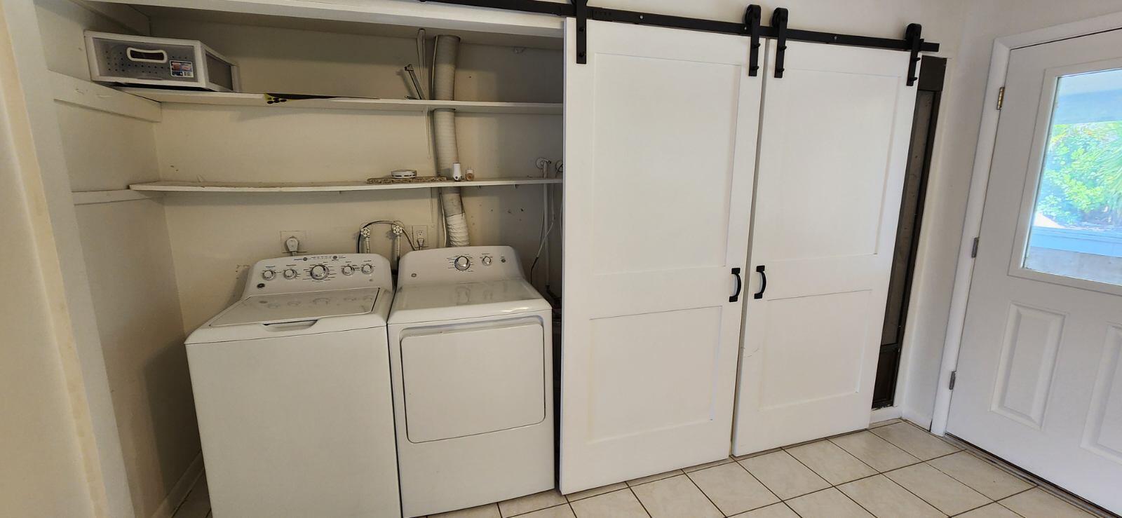 3831 Beacon Hill Road Jupiter, FL 33469 - Photo 9 of 9 a utility room with dryer and washer