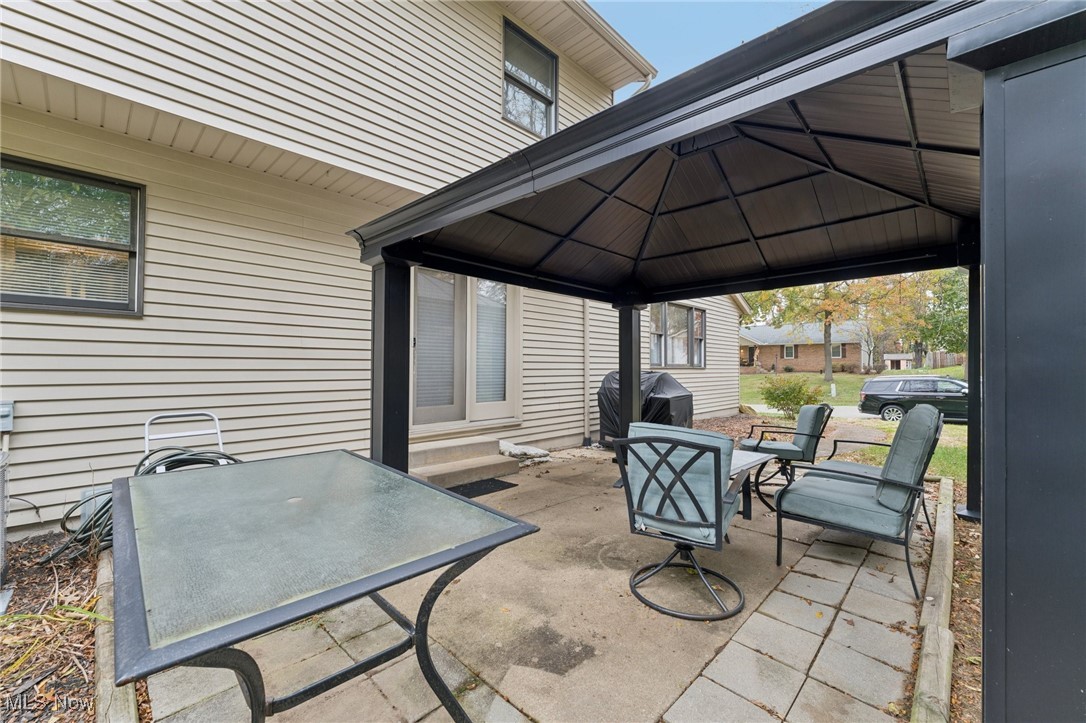 6930 Firestone Road Northeast Canton, OH 44721 - Photo 39 of 49 View of patio / terrace with outdoor dining space, a gazebo, and grilling area