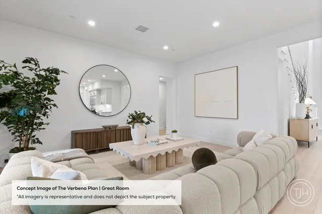 a living room with furniture a mirror and a potted plant