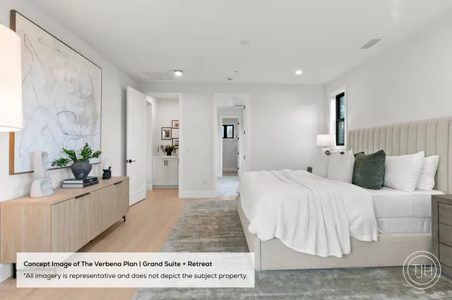 a spacious bedroom with a bed and a couch