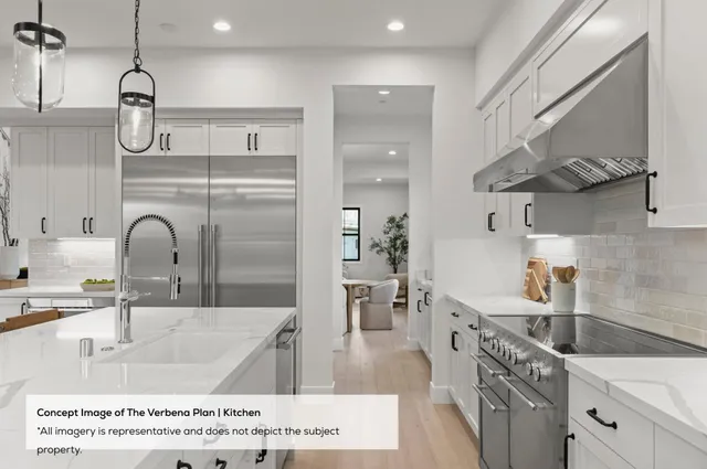 a kitchen with stainless steel appliances granite countertop a sink a stove and a refrigerator