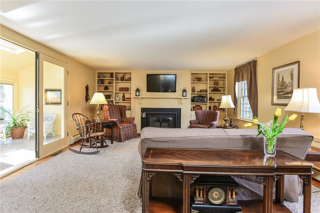 40 Bow Street East Greenwich, RI 02818 - Photo 16 of 35 Family room with fireplace opens to sun room