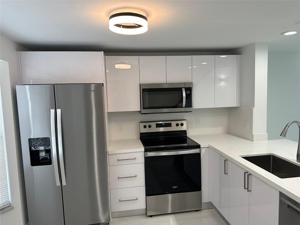 a kitchen with a refrigerator sink and microwave