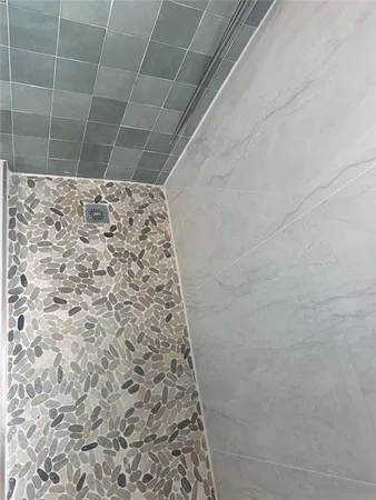 a bathroom with a glass shower door