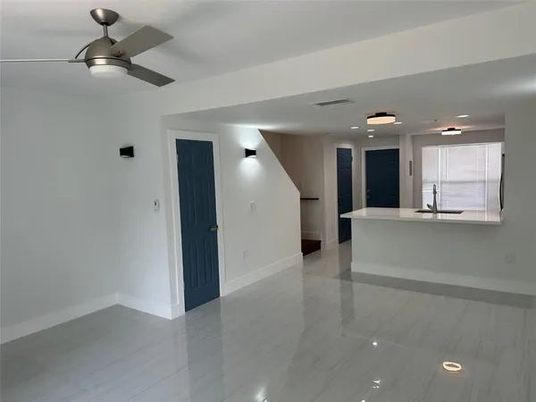 wooden floor in an empty room with a kitchen