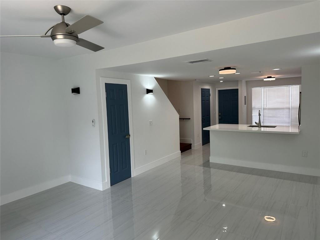 972 Jeffery Street Boca Raton, FL 33487 - Photo 3 of 18 wooden floor in an empty room with a kitchen