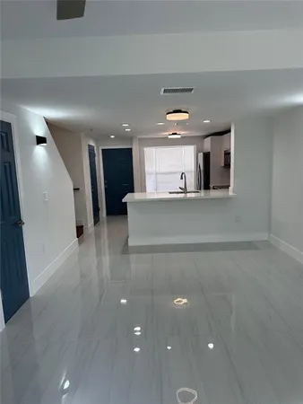 a view of a kitchen with a refrigerator and a window
