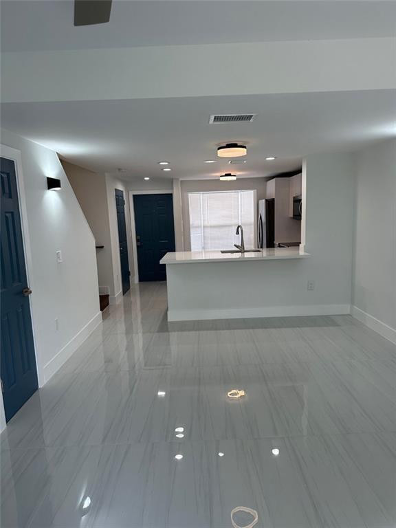 972 Jeffery Street Boca Raton, FL 33487 - Photo 4 of 18 a view of a kitchen with a refrigerator and a window