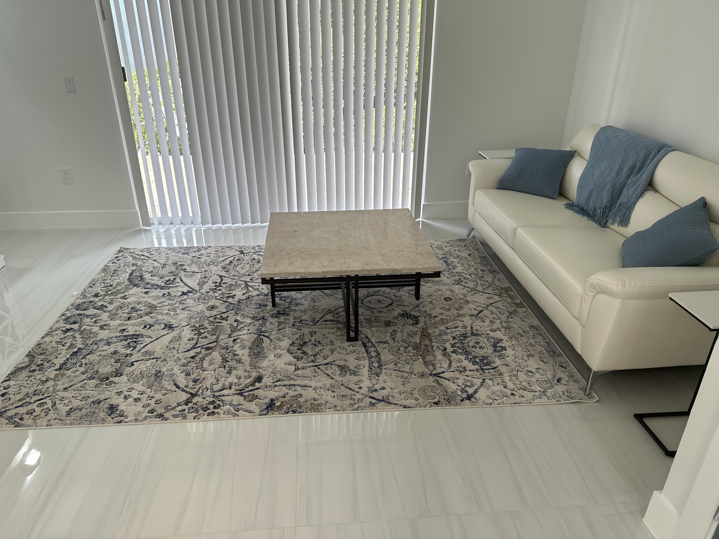 972 Jeffery Street Boca Raton, FL 33487 - Photo 5 of 16 a living room with a couch and a table