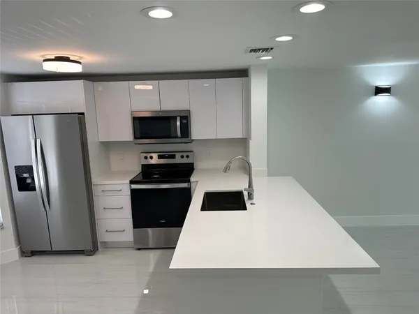 a kitchen with a refrigerator stove and microwave