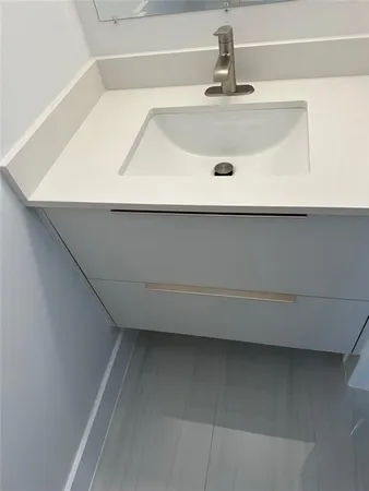 a bathroom with a sink and mirror