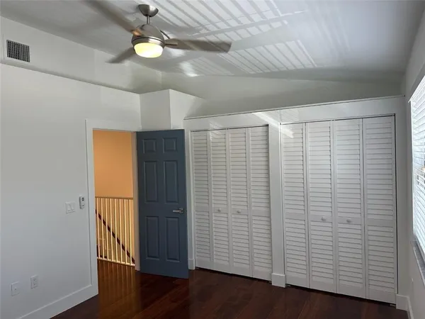 a view of a room with wooden floor and a window