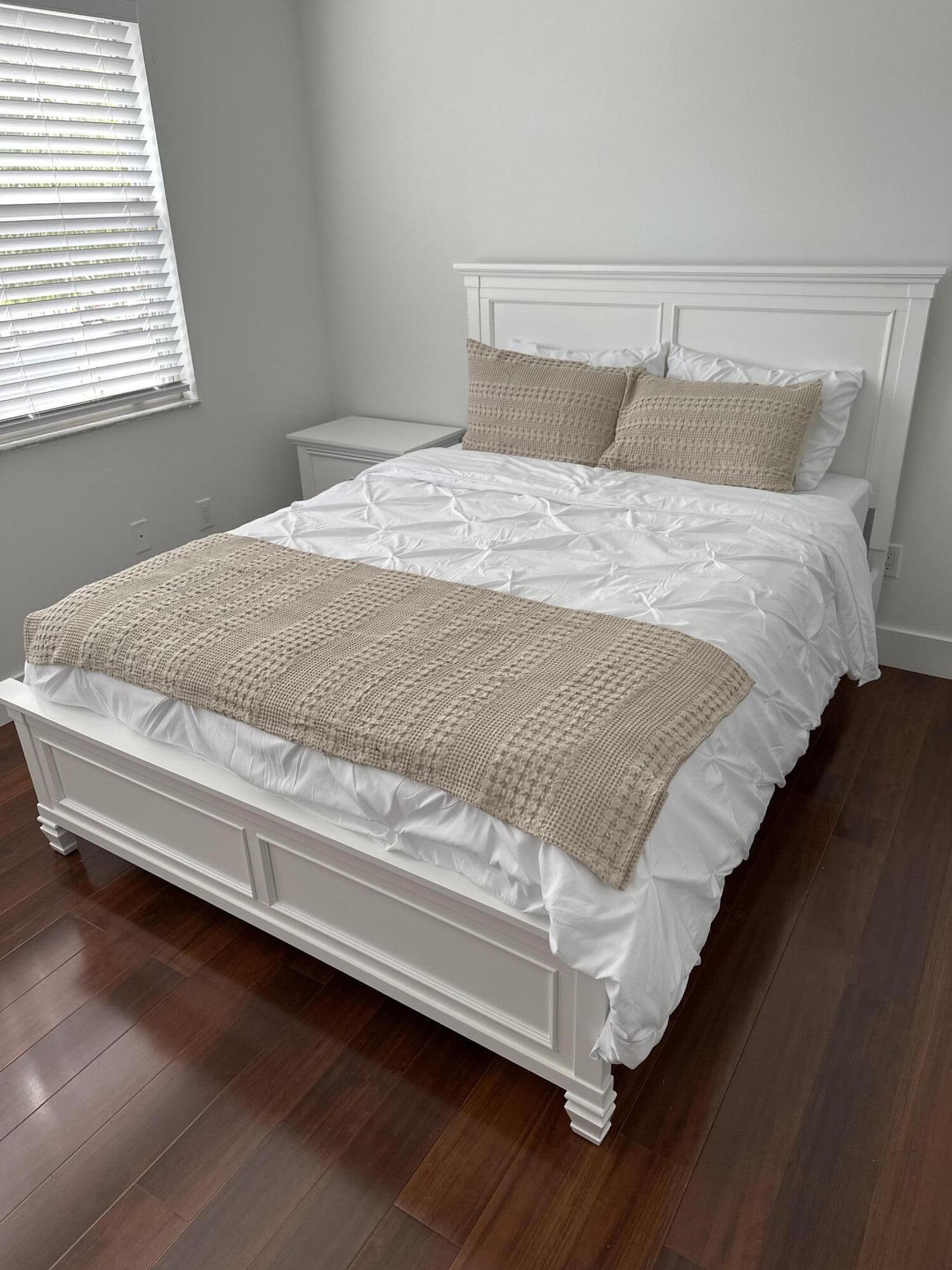 972 Jeffery Street Boca Raton, FL 33487 - Photo 9 of 16 a bed sitting in a bedroom next to a window