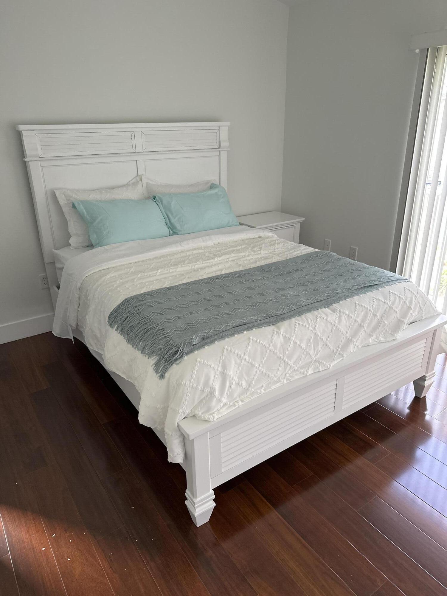 972 Jeffery Street Boca Raton, FL 33487 - Photo 10 of 16 a bedroom with a bed and wooden floor