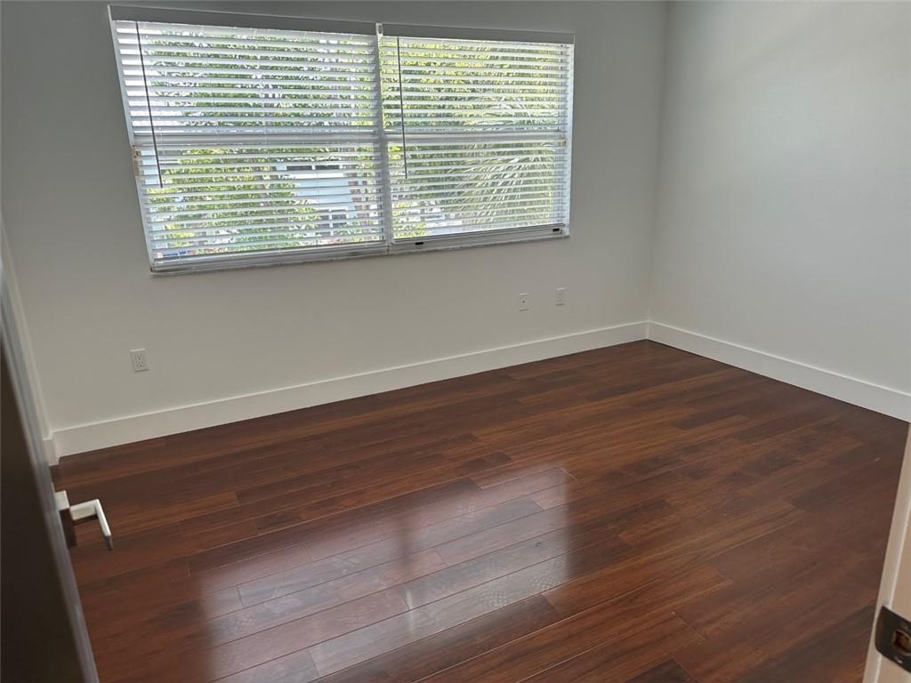 972 Jeffery Street Boca Raton, FL 33487 - Photo 10 of 18 a view of a room with wooden floor and a window
