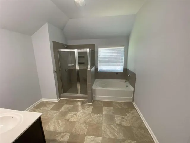 a bathroom with a tub and shower