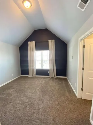 an empty room with a window and doors