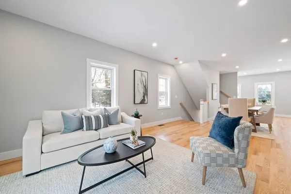 a living room with furniture and a wooden floor