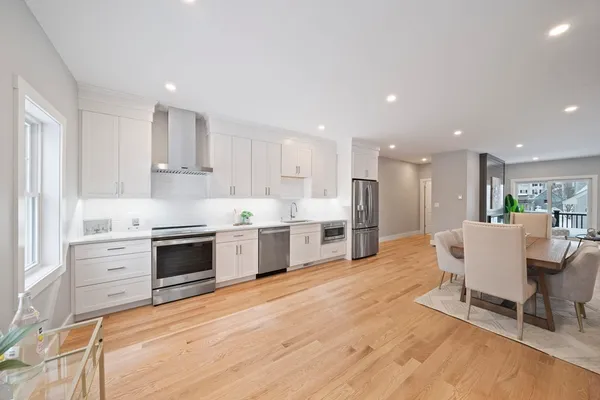 a kitchen with stainless steel appliances kitchen island granite countertop a stove a sink and a refrigerator