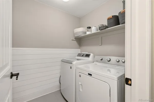 a view of a dining room with furniture and a chandelier