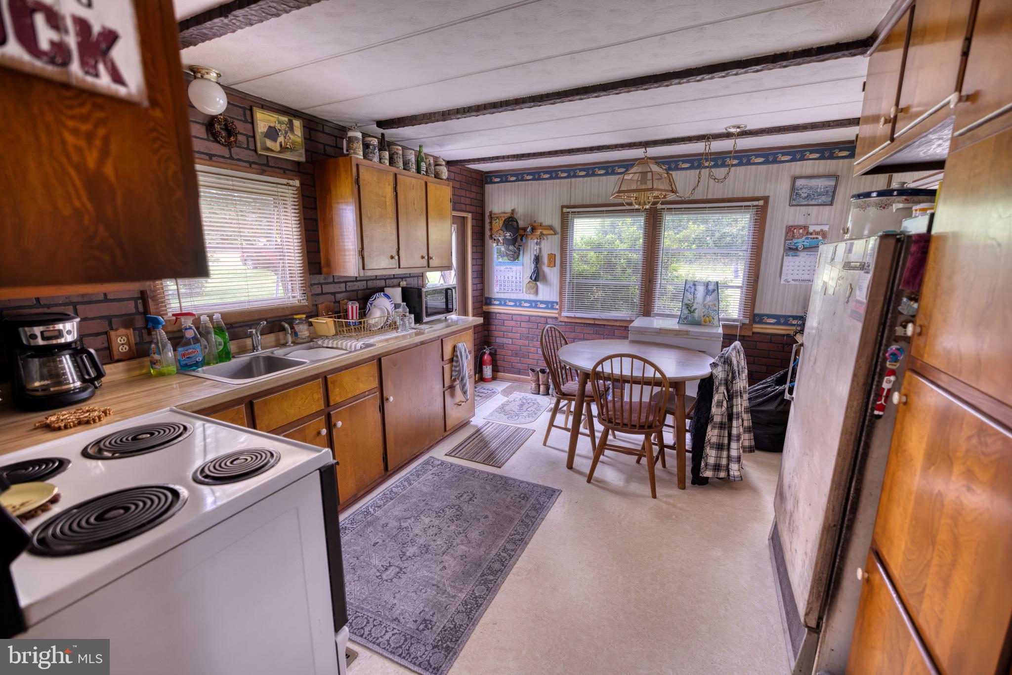 158 C Pleasant View Road Halifax, PA 17032 - Photo 18 of 59 a kitchen with a sink a stove and chairs