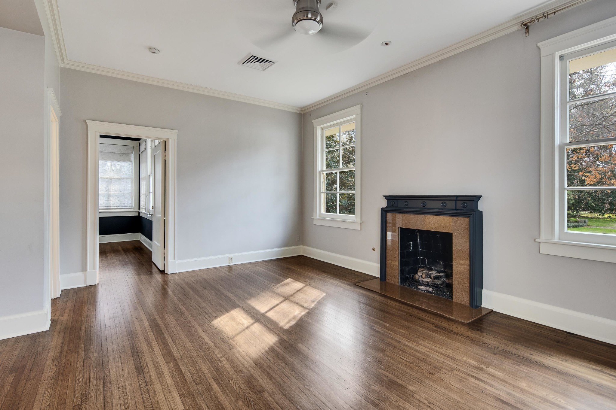 505 Goodwyn Street Memphis, TN 38111 - Photo 17 of 40 an empty room with wooden floor a fireplace and windows