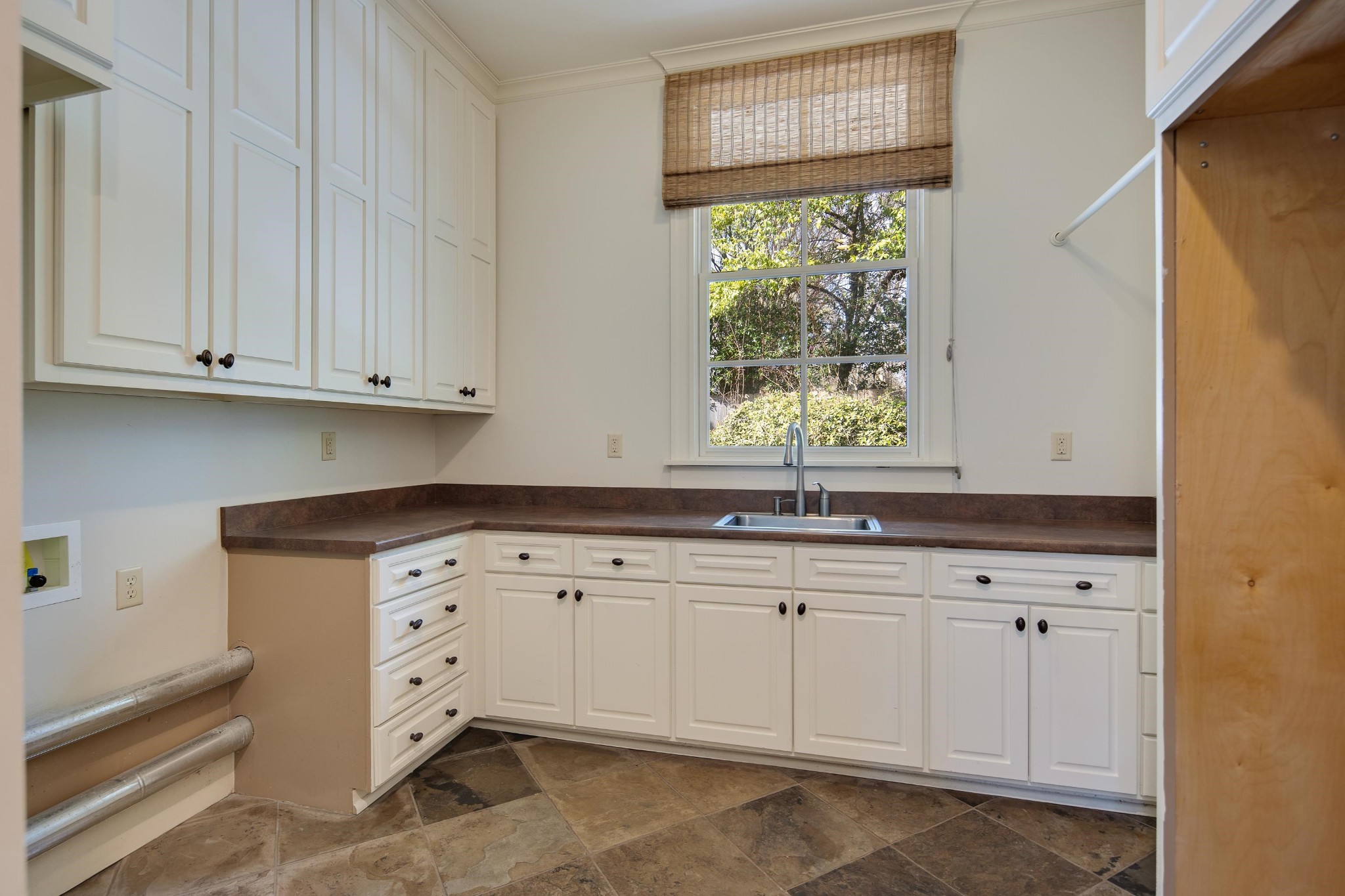 505 Goodwyn Street Memphis, TN 38111 - Photo 32 of 40 a kitchen with granite countertop white cabinets and window