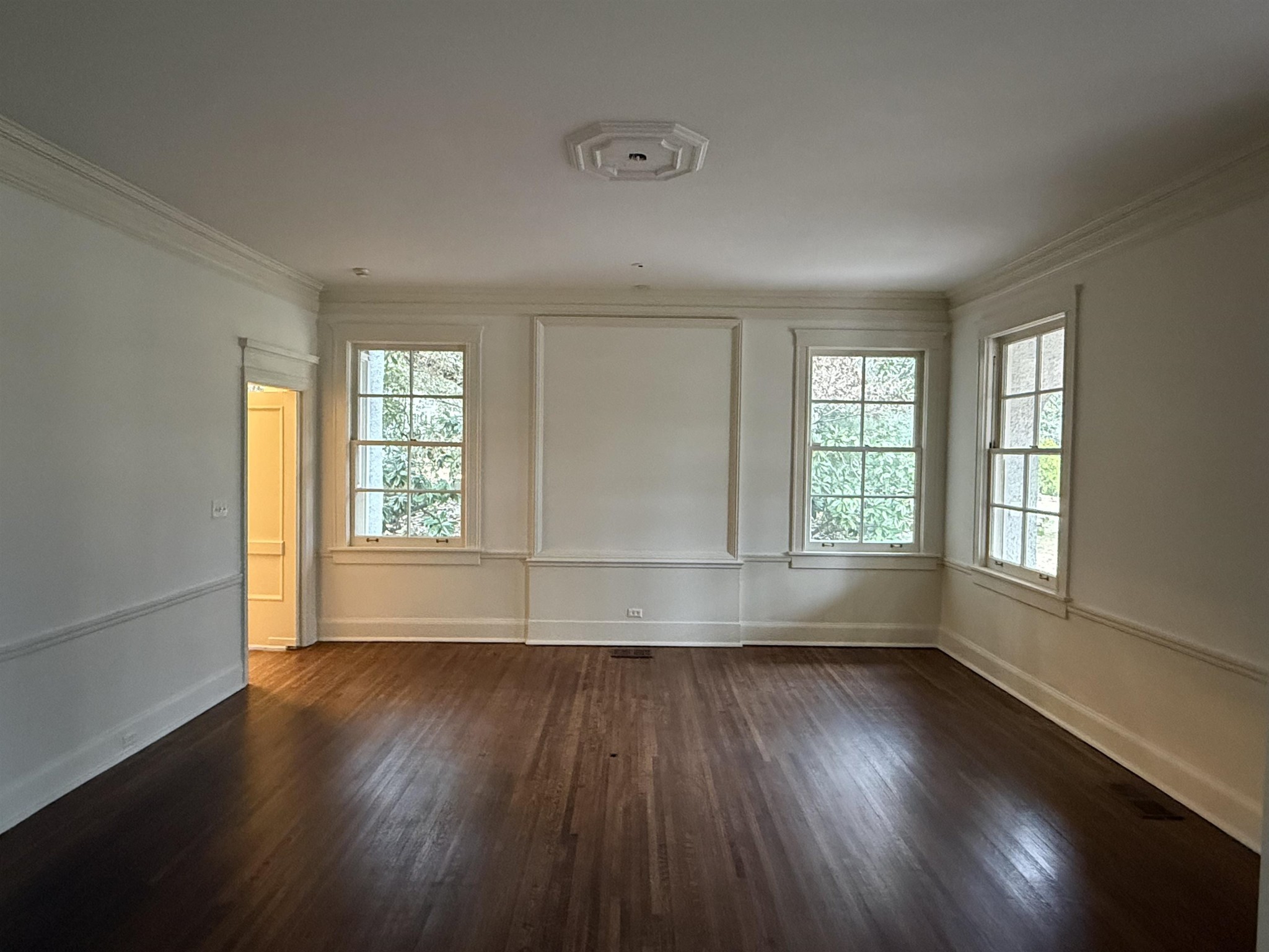 505 Goodwyn Street Memphis, TN 38111 - Photo 10 of 40 an empty room with wooden floor and windows