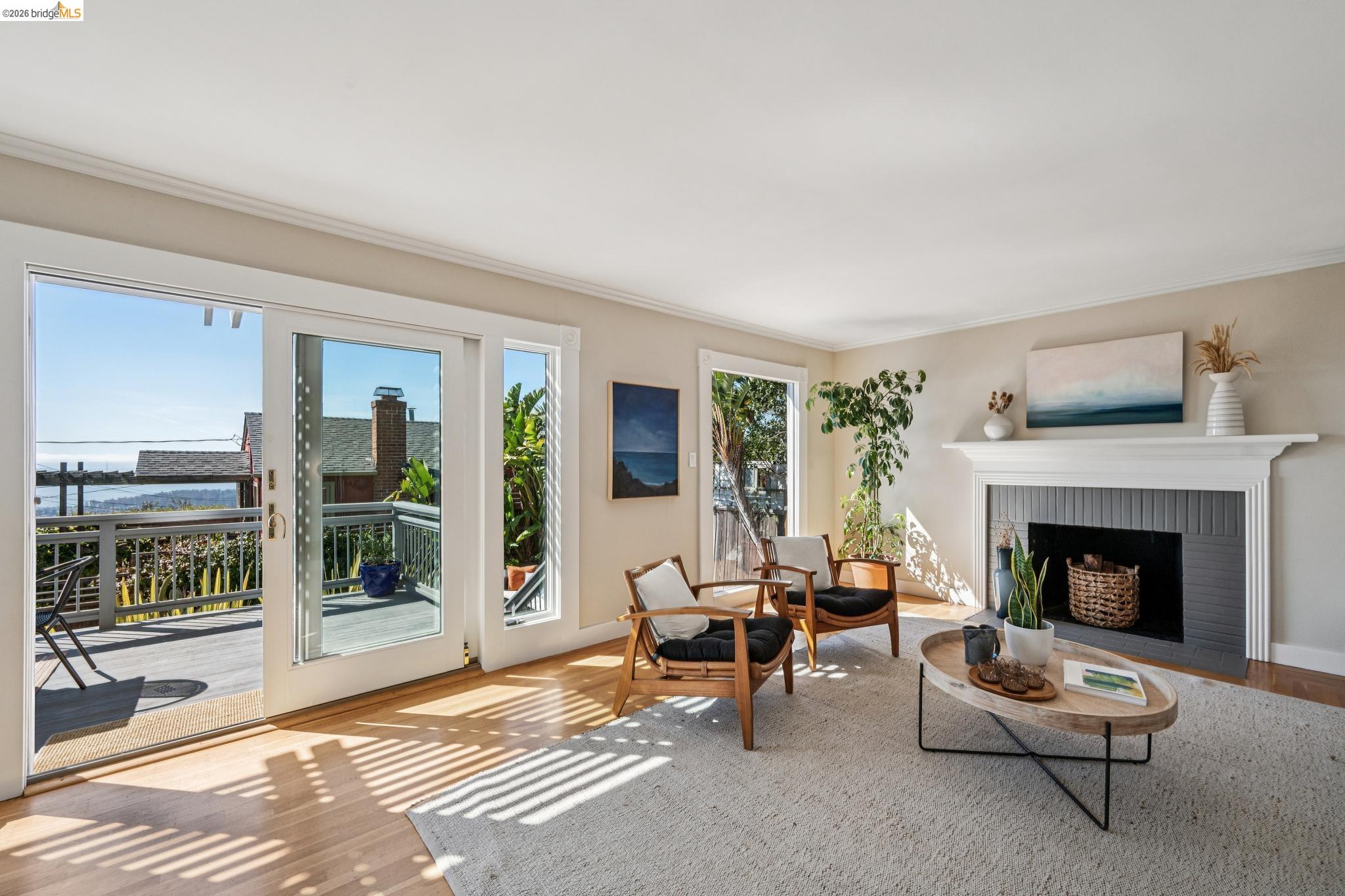 290 Colgate Avenue Kensington, CA 94708 - Photo 11 of 52 Living area featuring light wood finished floors, a fireplace, and ornamental molding