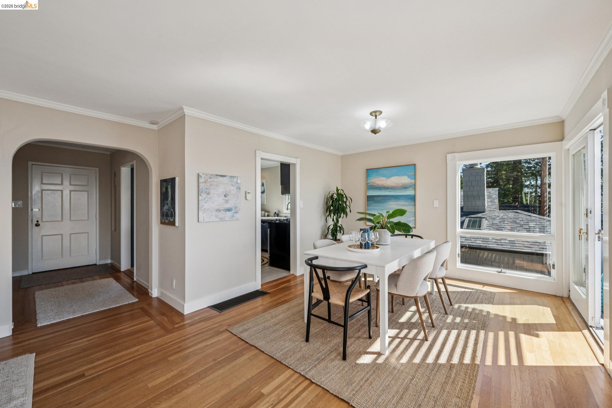 290 Colgate Avenue Kensington, CA 94708 - Photo 15 of 52 Dining area with arched walkways, light wood-style flooring, and crown molding