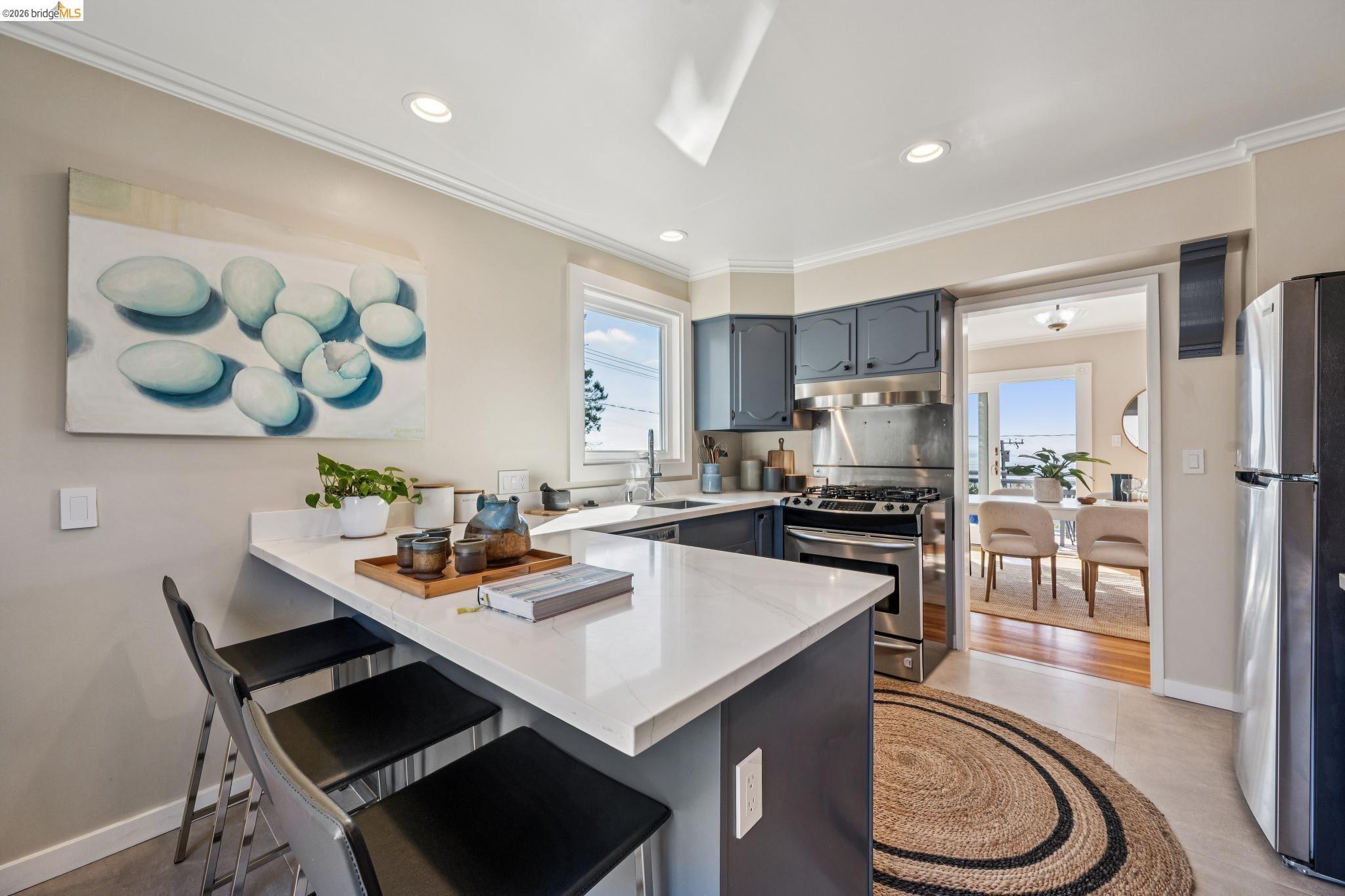 290 Colgate Avenue Kensington, CA 94708 - Photo 25 of 52 Kitchen with a kitchen bar, a peninsula, stainless steel appliances, recessed lighting, and crown molding
